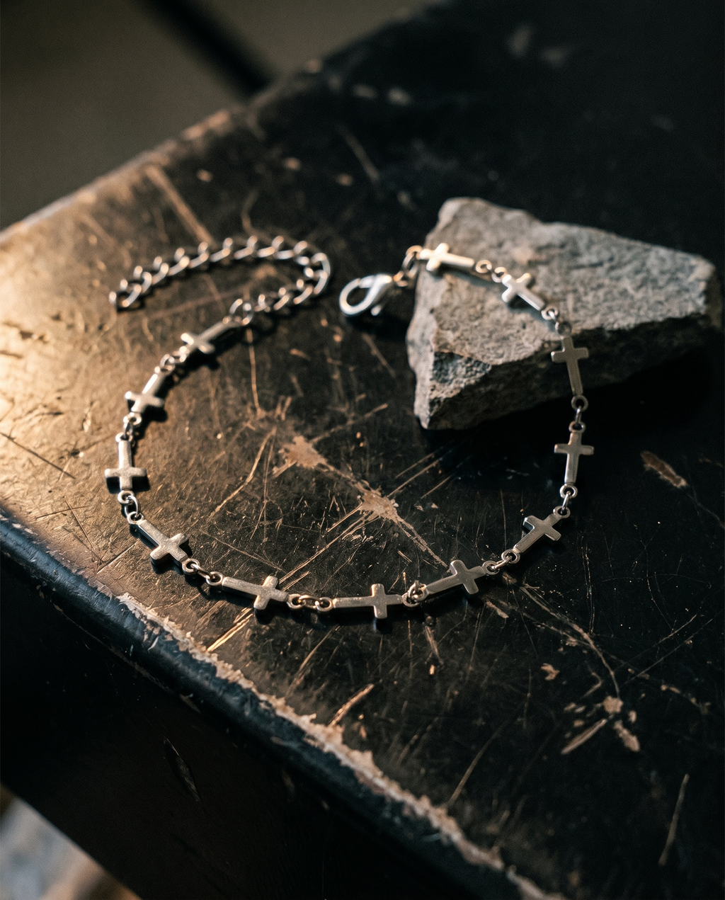 Relentless — silver row of small plain crosses