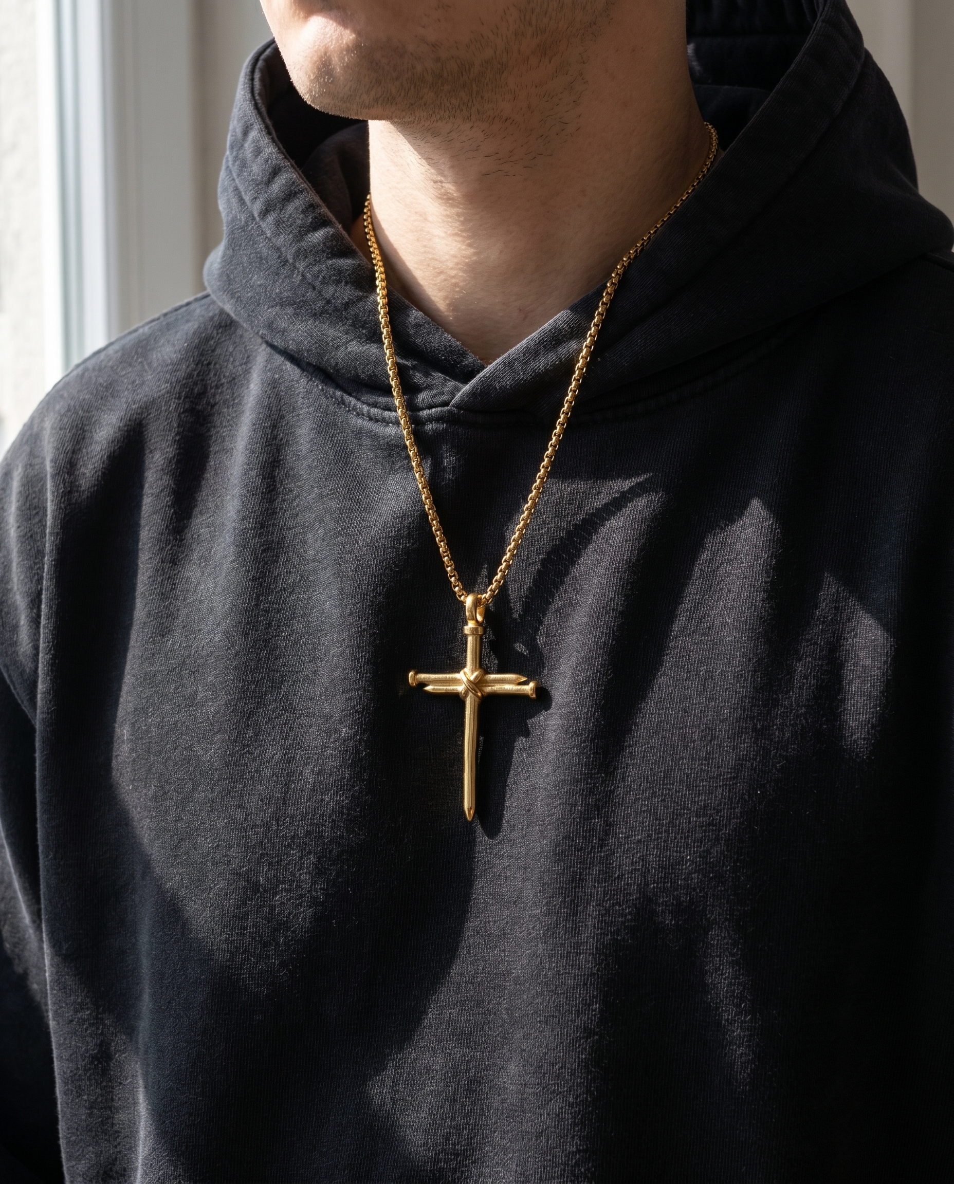 The Nails — gold cross formed of crossed nails
