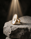 Inri — gold oval plaque, thin cross on mother-of-pearl