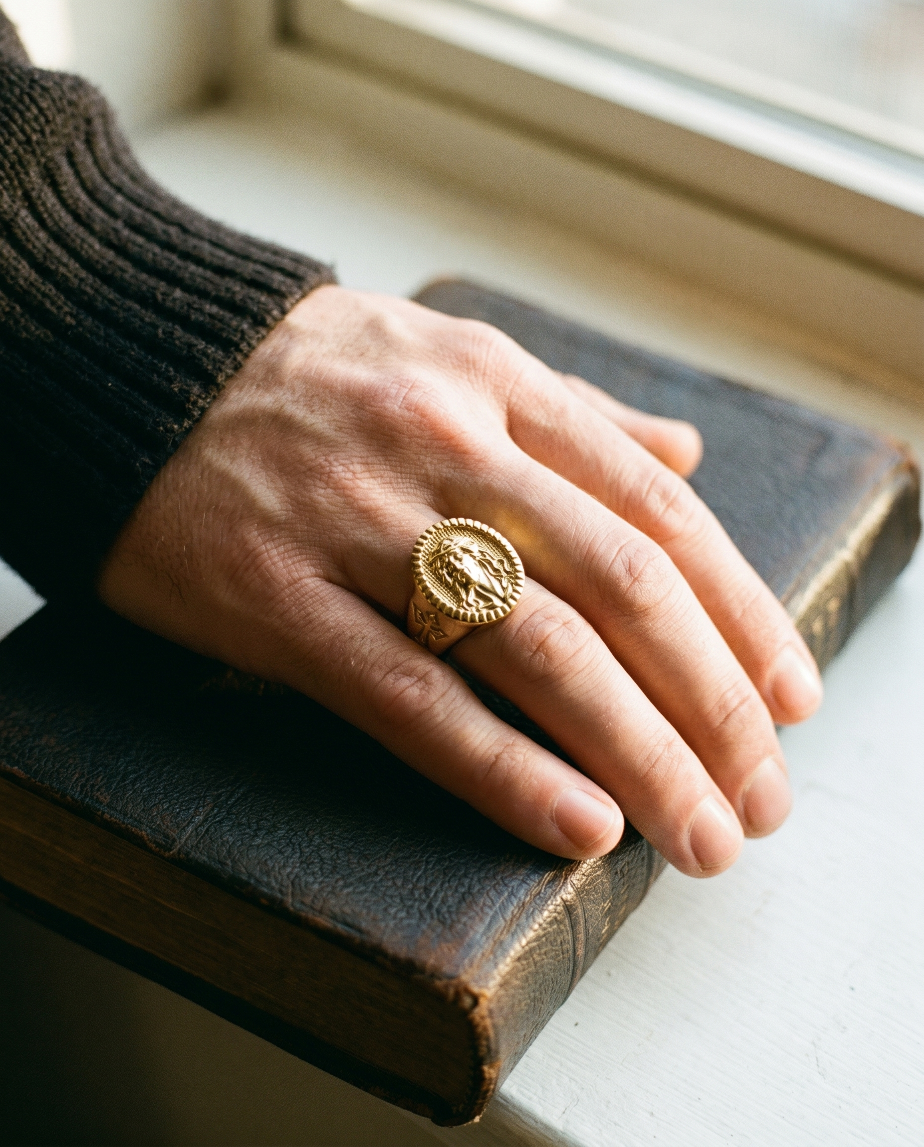 Icon — gold oval signet, Christ BUST + cross shank